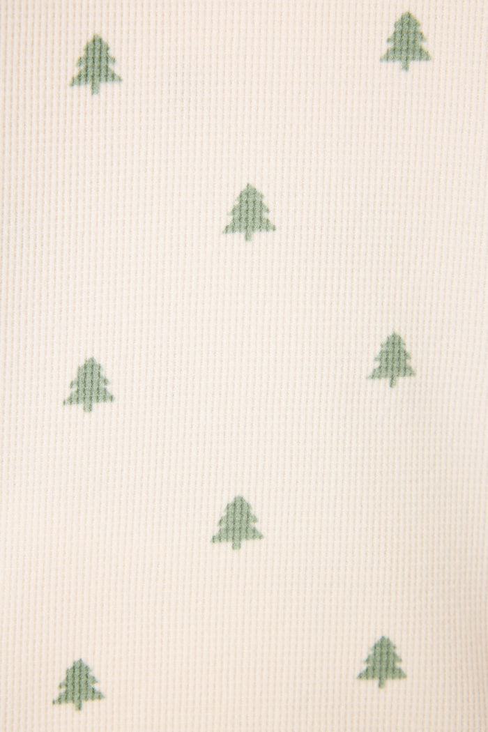 A close-up of the cream fabric from the P.J. Salvage 4-Piece Tree Print Thermal Lounge Set, showing green tree motifs in neat rows—ideal for cozy winter lounging.