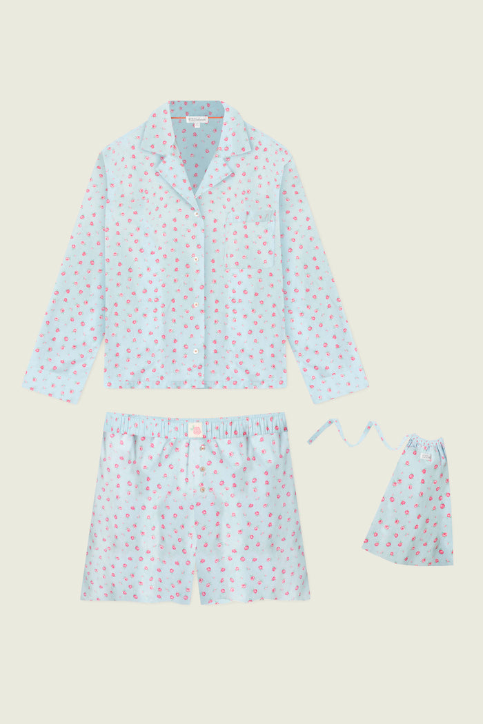 The Afterparty Poplin Rosy Nights Short PJ Set by P.J. Salvage features soft cotton poplin in light blue with a pink rose print, including a long-sleeve button-up top, elastic waistband shorts, and a matching pouch.
