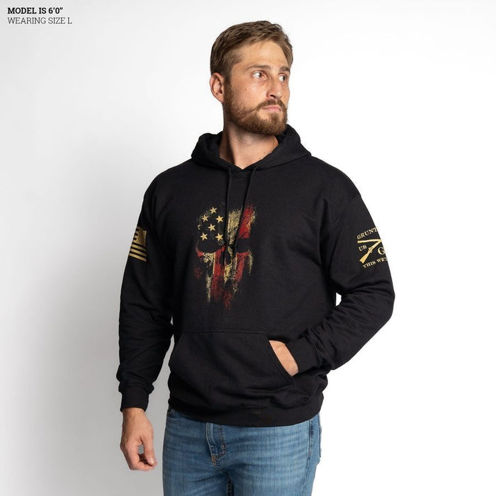 Man wearing a black hoodie with a graphic design on a white background