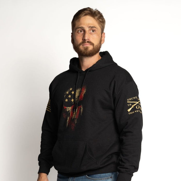 Man wearing a black hoodie with a graphic design on a white background