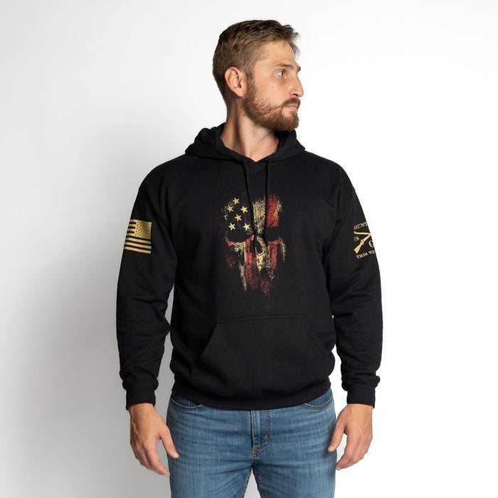 Man wearing a black hoodie with a graphic design on a white background