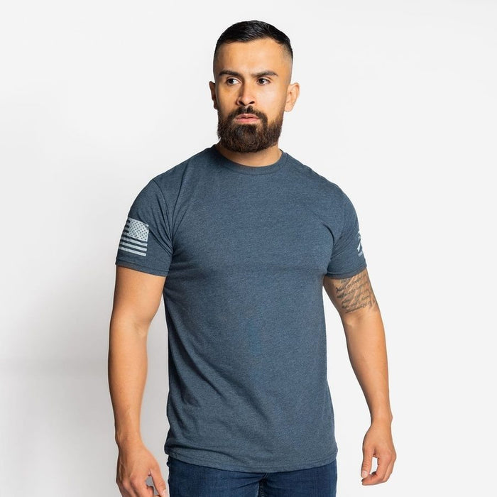 Man wearing a blue t-shirt with a flag design on a white background