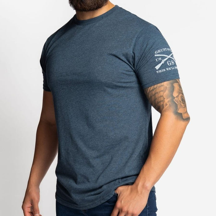 Man wearing a blue t-shirt with a logo on a white background