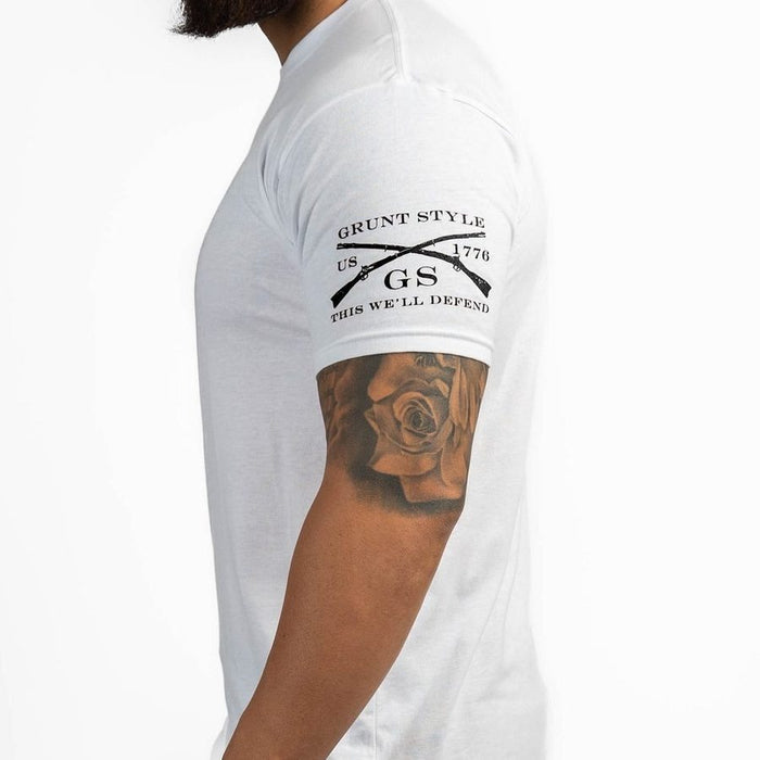 Person wearing a white t-shirt with 'Grunt Style' logo and text, visible tattoo on arm.