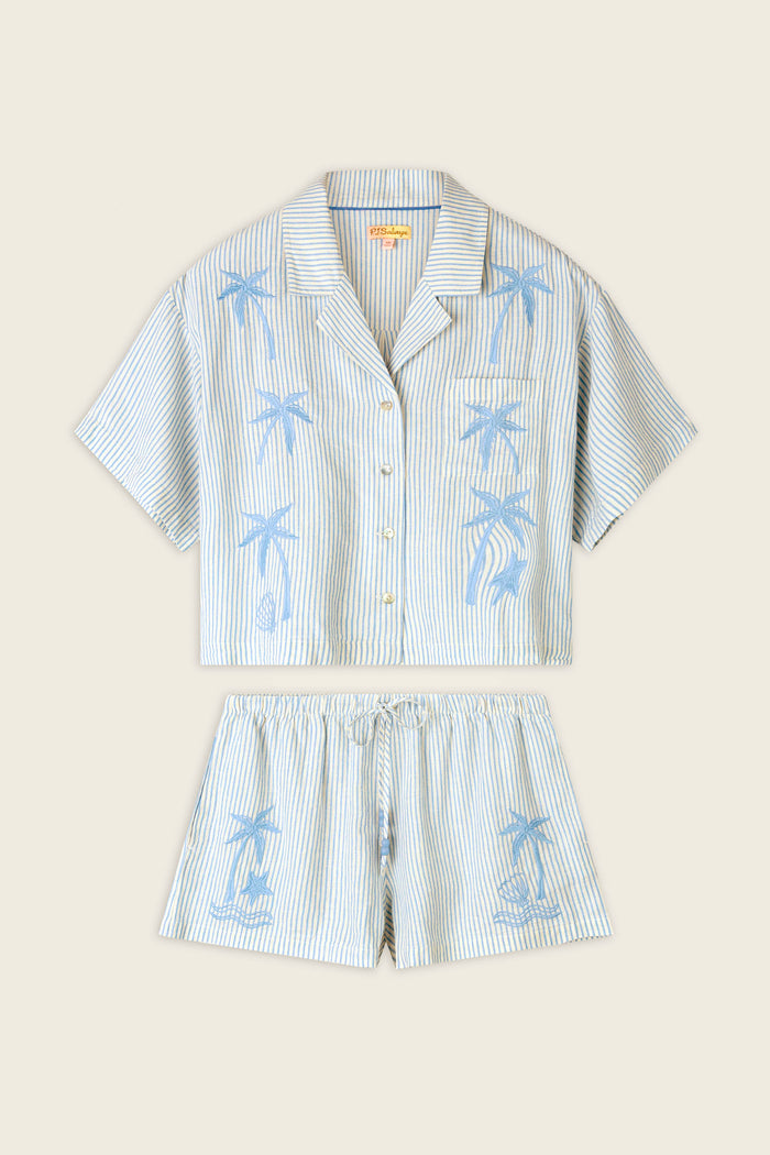 Thin blue and white stripes with blue palm tree lettering on a smooth fabric, shown flat against a neutral background.