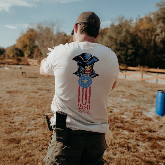 Man wearing a white t-shirt with a graphic design outdoors