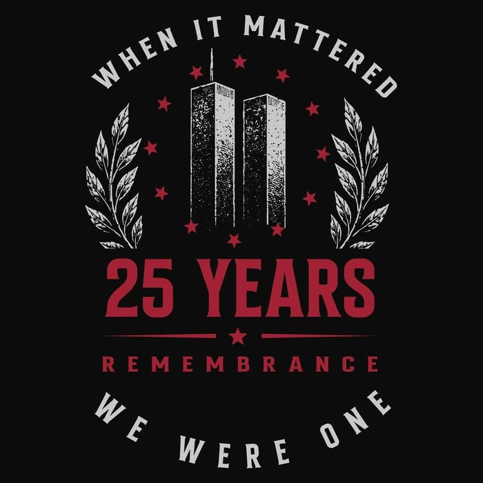 A black graphic print featuring the text 'WHEN IT MATTERED 25 YEARS REMEMBRANCE WE WERE ONE' with a central memorial design of two towers, red stars, and white laurel branches.