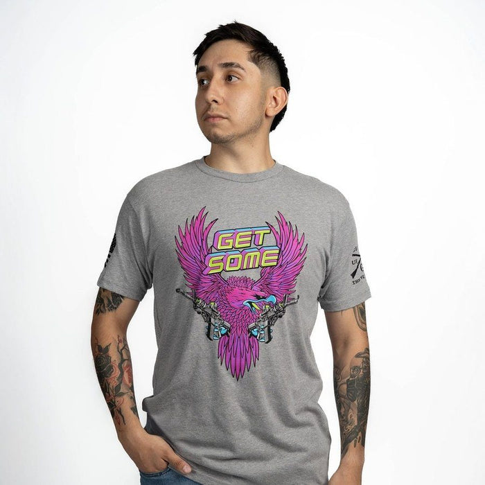 Man wearing a gray t-shirt with a colorful graphic design on a white background