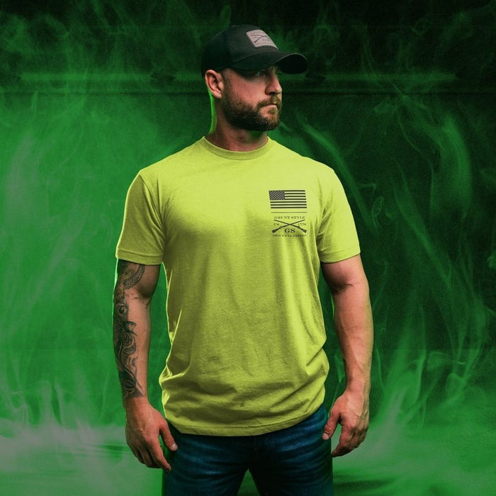 Man wearing a bright green t-shirt with a logo on a green background