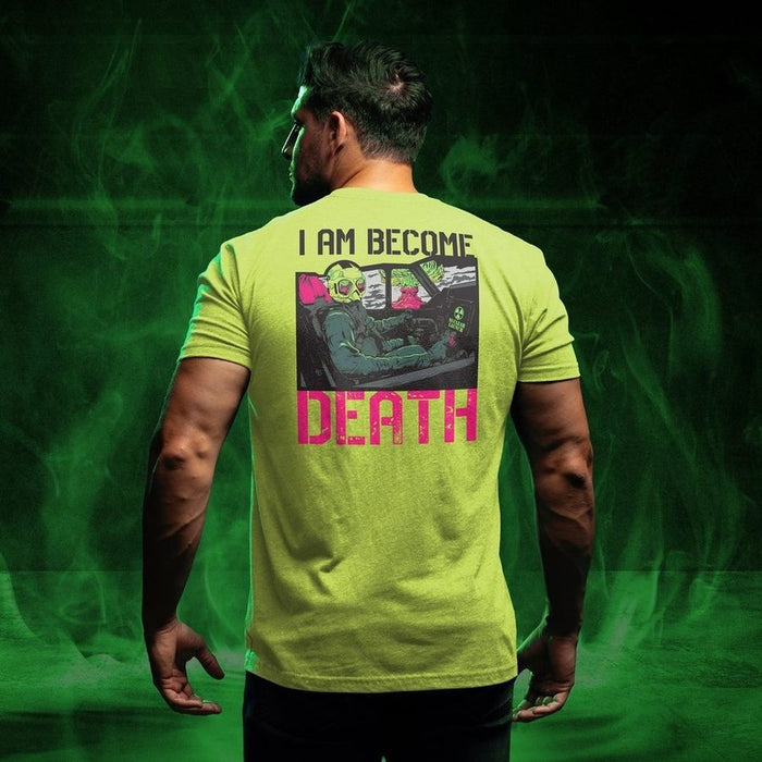 Person wearing a bright green t-shirt with text and graphic design on the back, standing against a green smoke background.