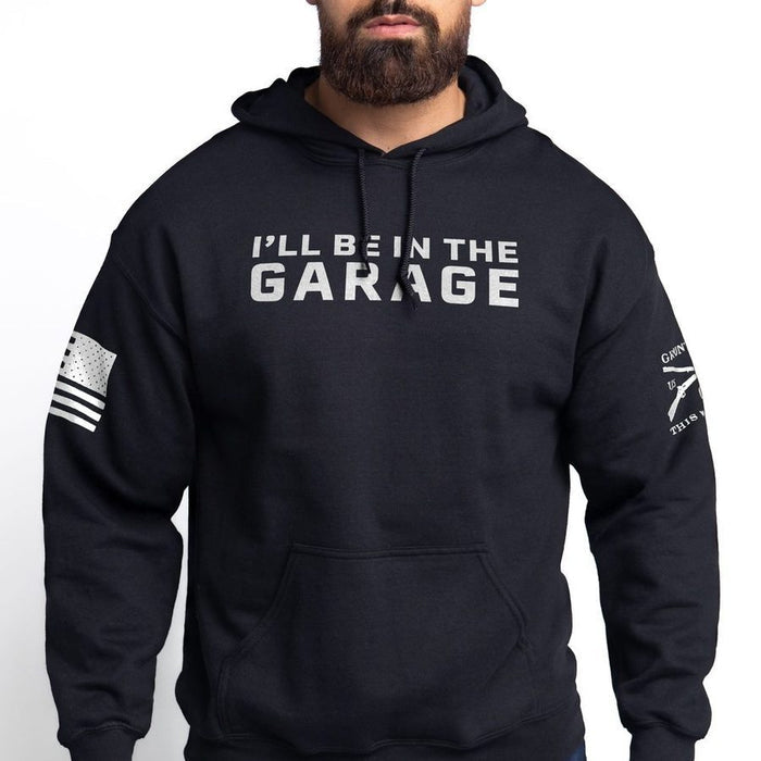 Black hoodie with 'I'll be in the garage' text on a white background