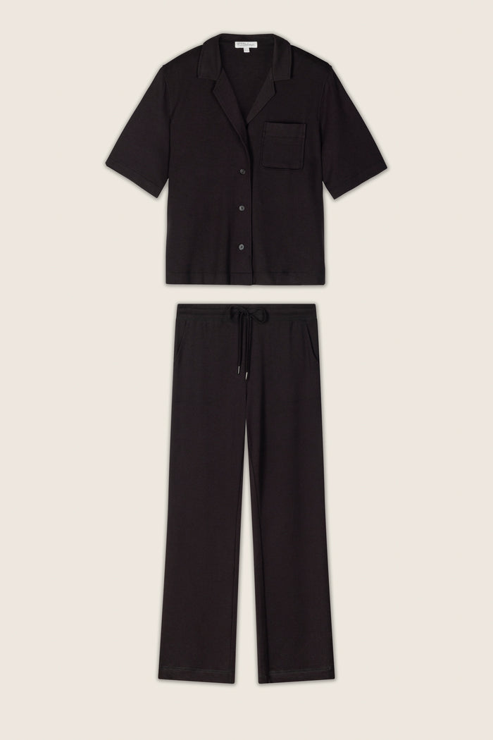 The black baby terry knit fabric has a soft, slightly textured appearance and is displayed on a neutral background.