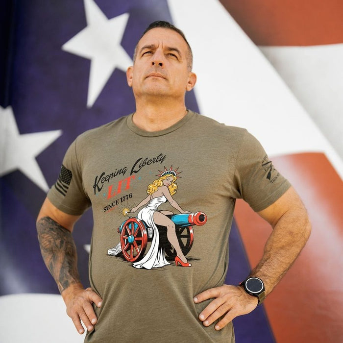 Man wearing a graphic t-shirt with a design in front of an American flag.