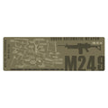 An olive drab green rectangular graphic print featuring a technical schematic of an M249 Squad Automatic Weapon with labeled parts, a rifle silhouette, and large 'M249' text on a white background.