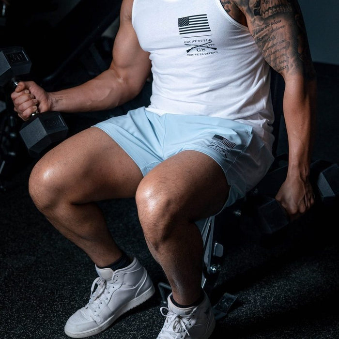 Person exercising with dumbbells in a gym setting