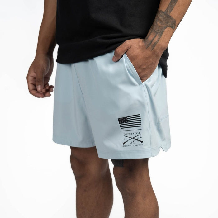 Light blue shorts with a logo on the side worn by a person against a white background