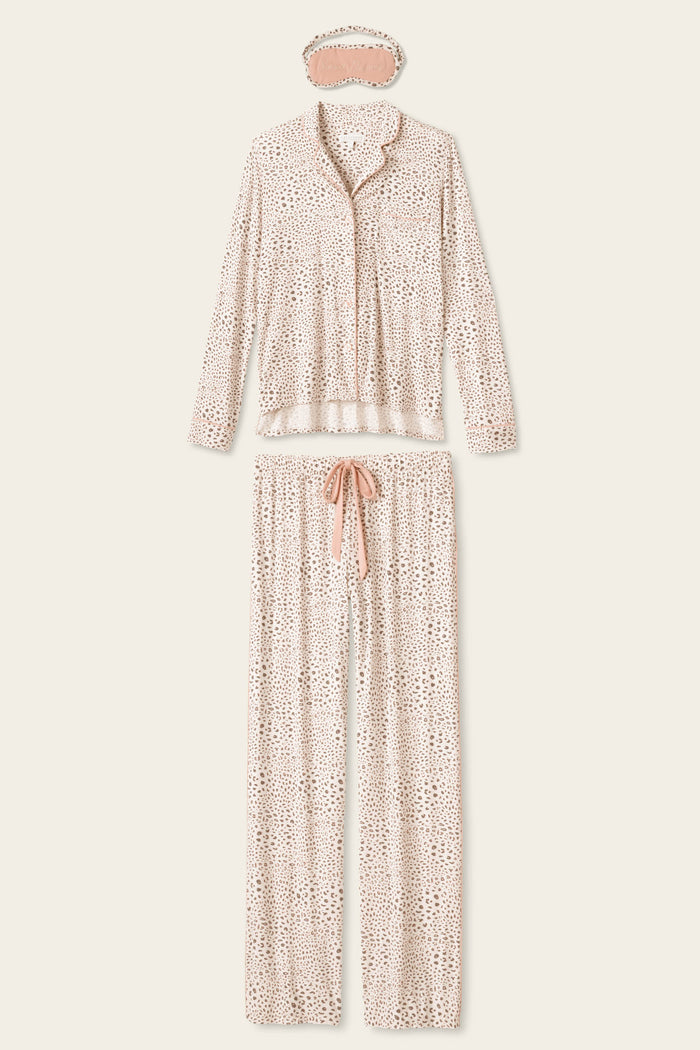 The Modal Dreams Leopard Print 3-Piece PJ Set by P.J. Salvage includes a soft modal jersey long-sleeve button-up top, drawstring pants, and a matching sleep mask in light beige with a small brown spotted pattern.