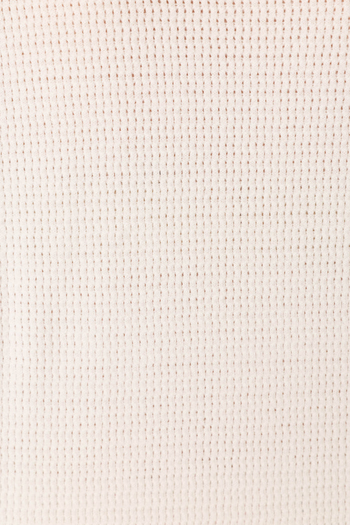 A close-up of the Playful Prints Bon Voyage Pullover Sweater by P.J. Salvage, showcasing its ivory waffle-knit fabric and soft, grid-like textured pattern.