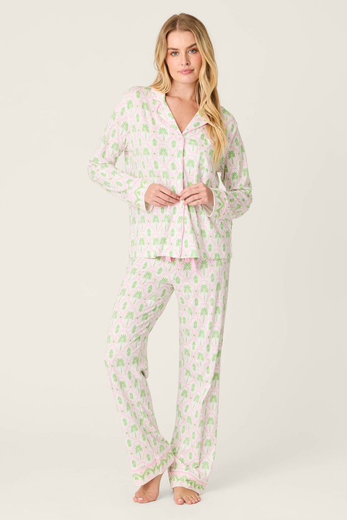 A woman wearing the P.J. Salvage Playful Prints Island Time Long Sleeve Top, crafted from soft cotton-modal jersey, is smiling.