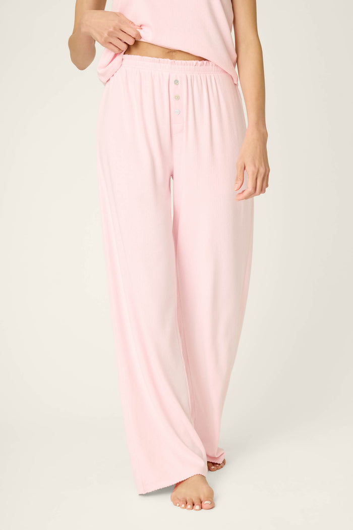 A person wearing P.J. Salvage Pointelle Essentials Ballet Pink Open Leg Pants stands barefoot against a plain light background, with only the lower half of their body shown.