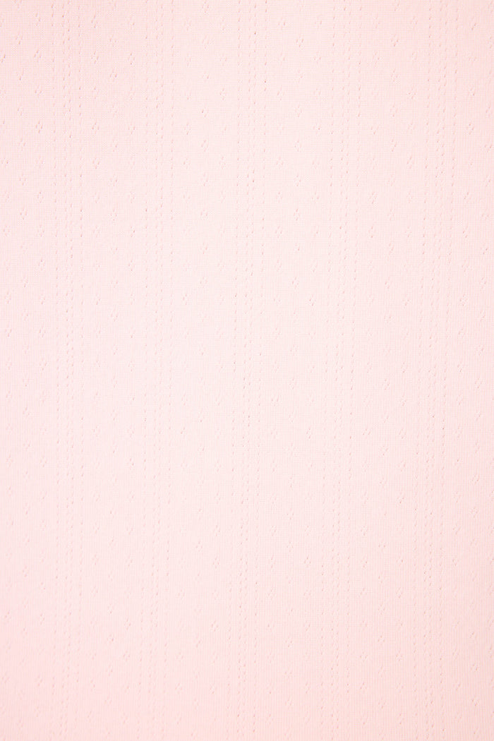 The Pointelle Essentials Ballet Pink Cardigan by P.J. Salvage features a light pink, textured surface with subtle vertical dotted lines and a faint diamond pattern, creating a consistent and elegant look throughout.