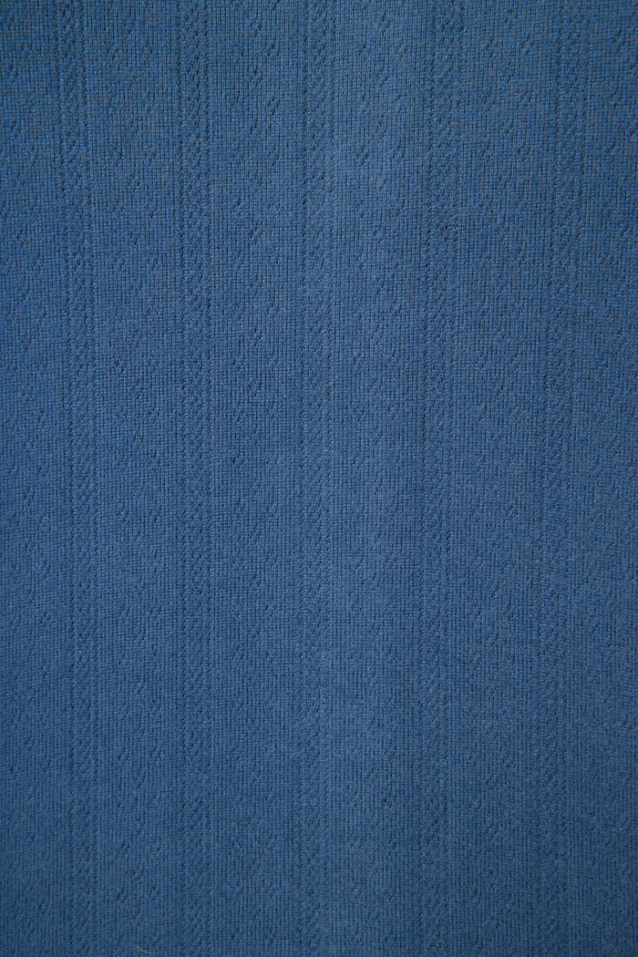 Close-up of the P.J. Salvage Pointelle Essentials Deep Sea Open Leg Pants, showing textured blue fabric with vertical lines and a subtle woven pointelle pattern—ideal for lounge wear with small raised designs throughout.
