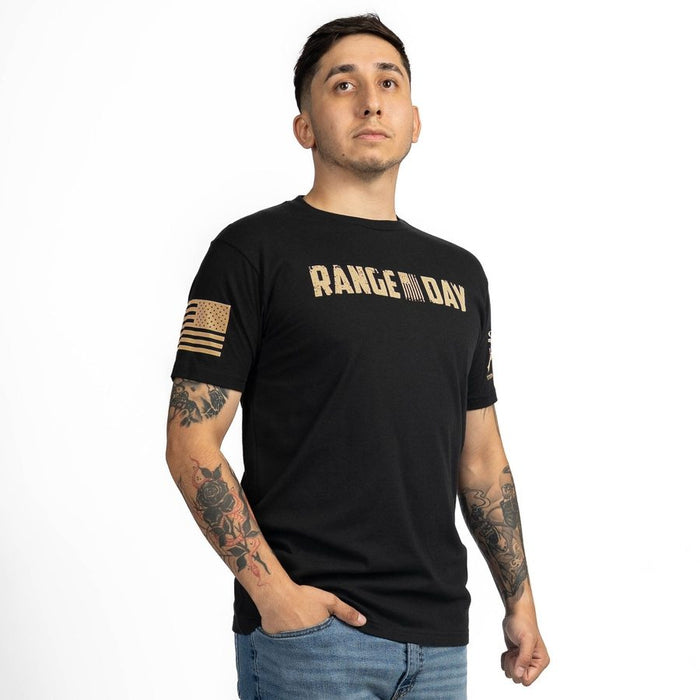 Man wearing a black t-shirt with 'RANGE DAY' text and tattoos on arms against a white background