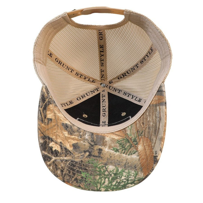 An open-front trucker hat shown from the back, featuring a beige mesh back and a camouflage-patterned brim with brown, green, and tan tones. The word 'GRUNT' is printed repeatedly on the center back panel.