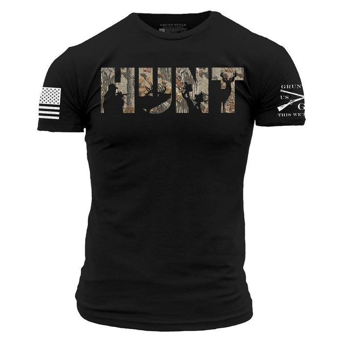 A black short-sleeve t-shirt with the text 'CAN'T FIX STUPID' printed in white across the chest. The left sleeve features a distressed white American flag graphic, and the right sleeve has a white graphic with crossed rifles and the text 'GRUNGER USA THIS WEEK'.