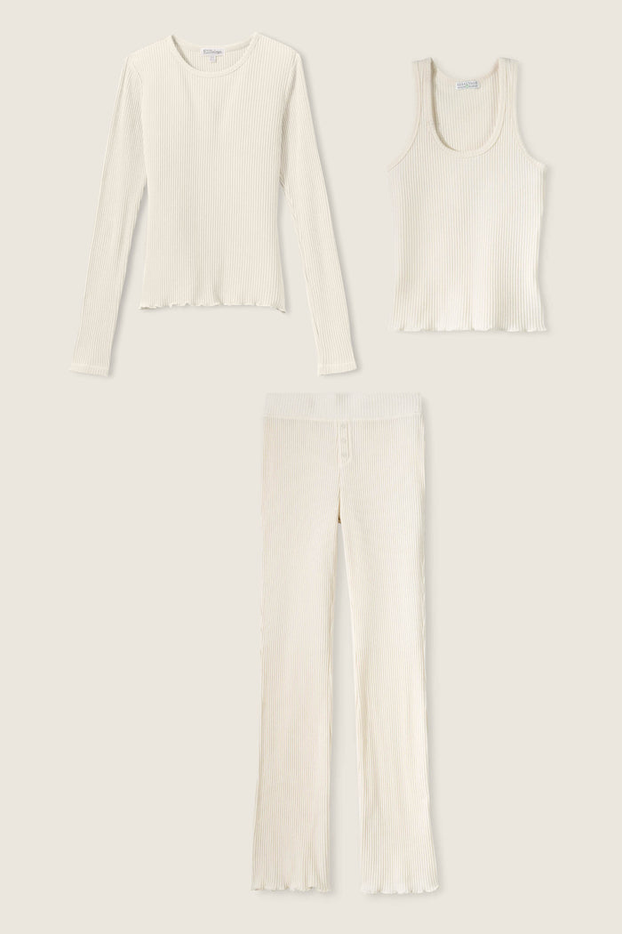 The P.J. Salvage Reloved Rib Natural 3-Piece Lounge Set features a cream ribbed long-sleeve top, sleeveless tank, and high-waisted pant with lettuce hems—crafted from sustainable REPREVE yarn.