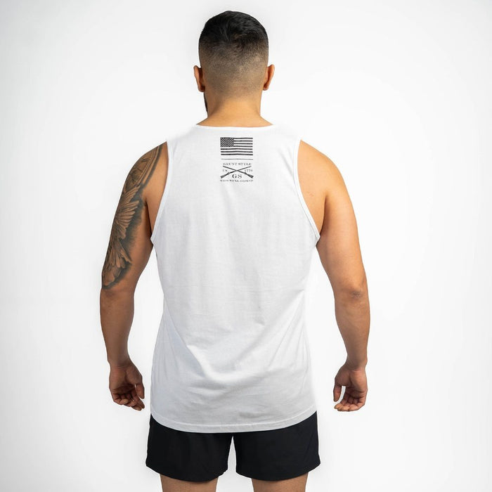 Man wearing a white tank top with a logo on the back against a white background
