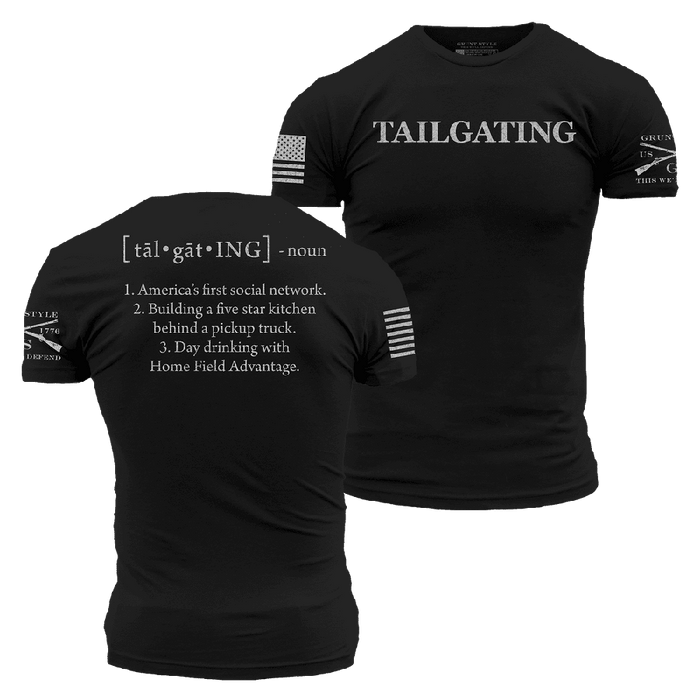 Black short-sleeve T-shirt shown from both front and back on a white background. The front has the word "TAILGATING" printed in white across the chest, and the back has a dictionary-style definition printed in white.