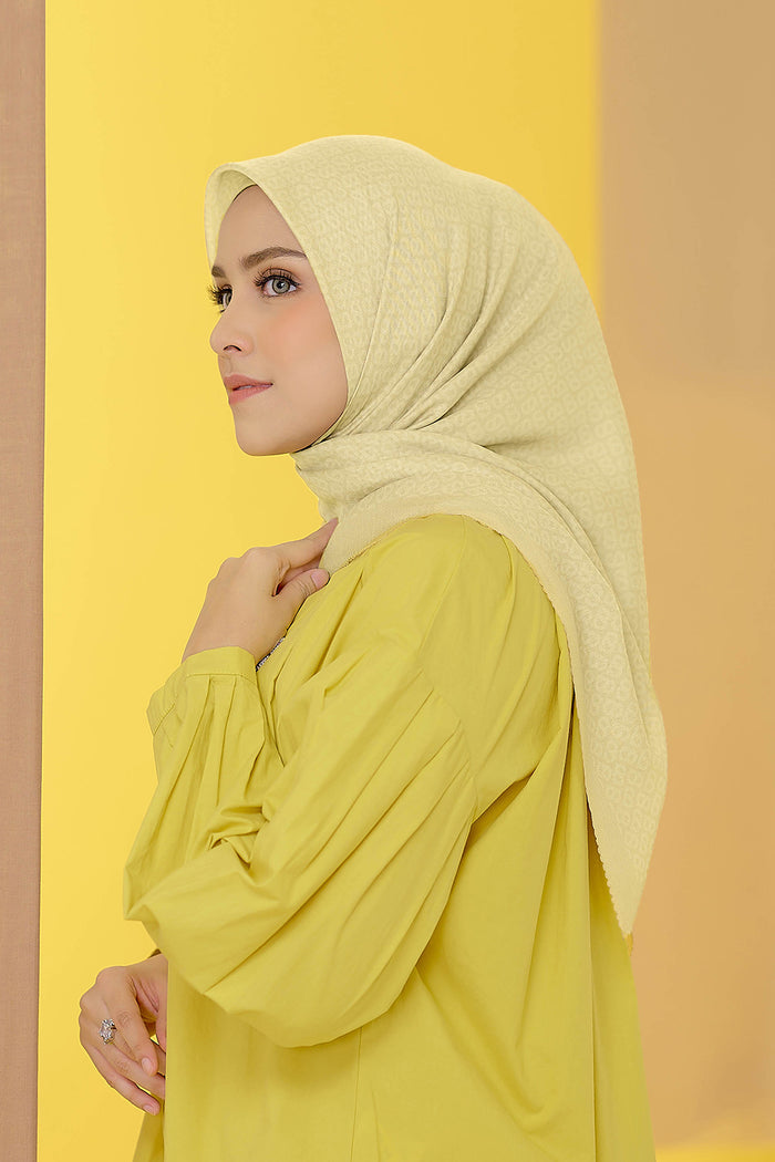the tapis square scarf in bleached sand by buttonscarves side view