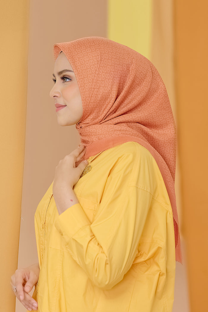 the tapis square scarf in tangerine by buttonscarves side view