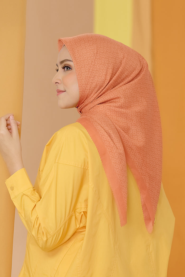 the tapis square scarf in tangerine by buttonscarves side view