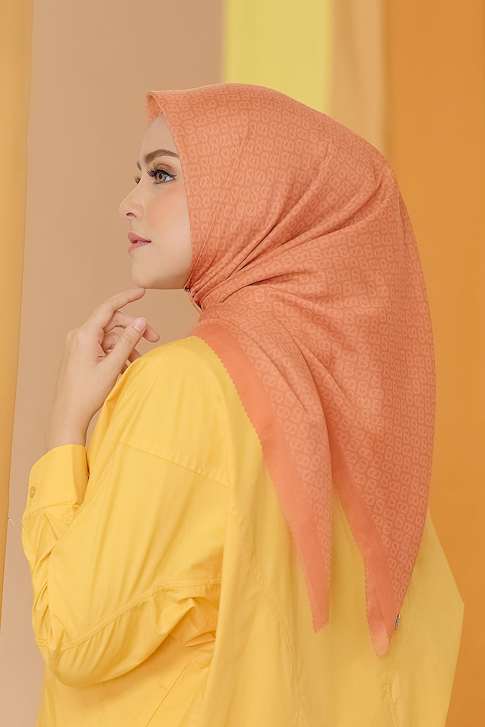 the tapis square scarf in tangerine by buttonscarves side view