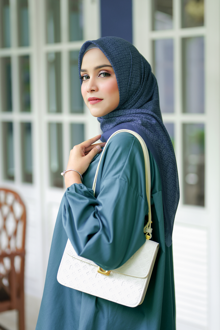 the tapis square scarf in teal by buttonscarves side view
