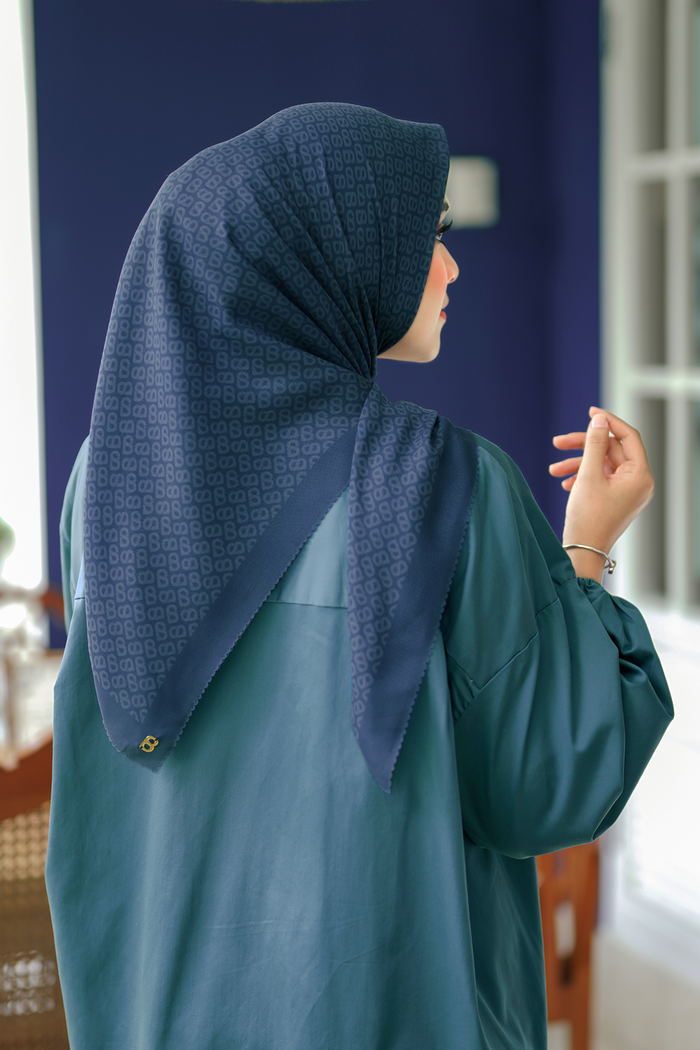 the tapis square scarf in teal by buttonscarves back view