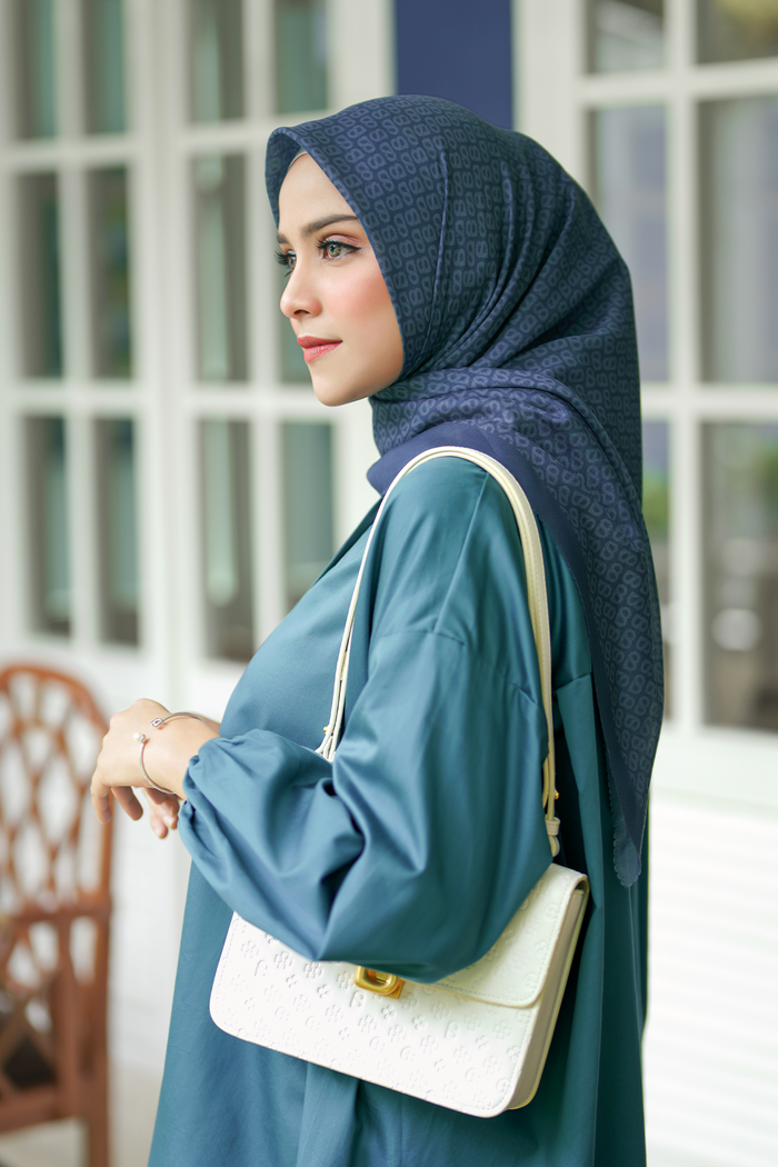 the tapis square scarf in teal by buttonscarves side view