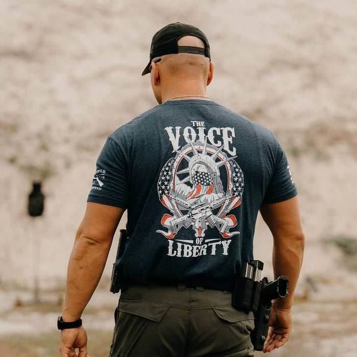 Man wearing a t-shirt with 'The Voice of Liberty' design outdoors.