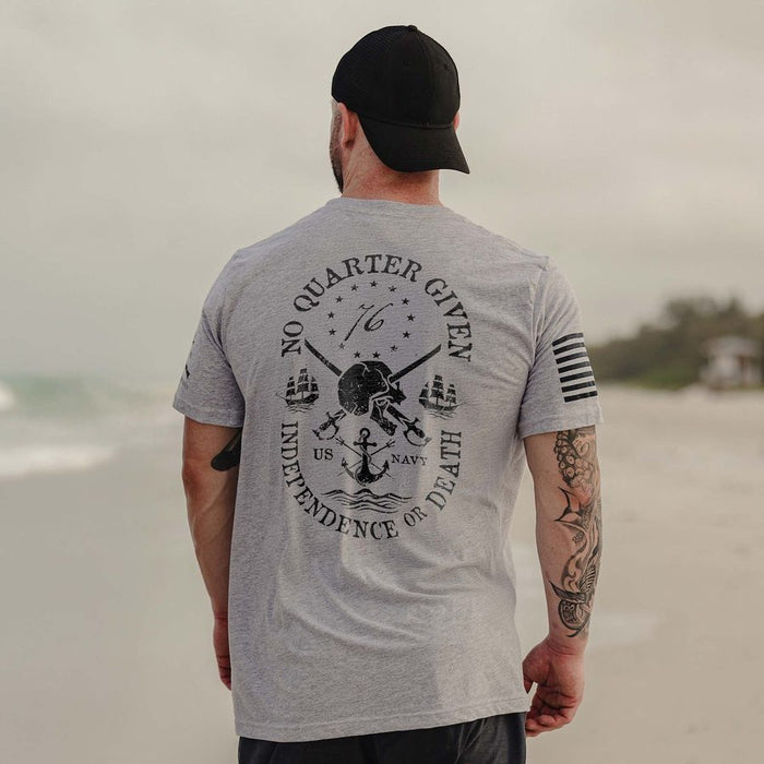 Man wearing a gray t-shirt with a design on the beach