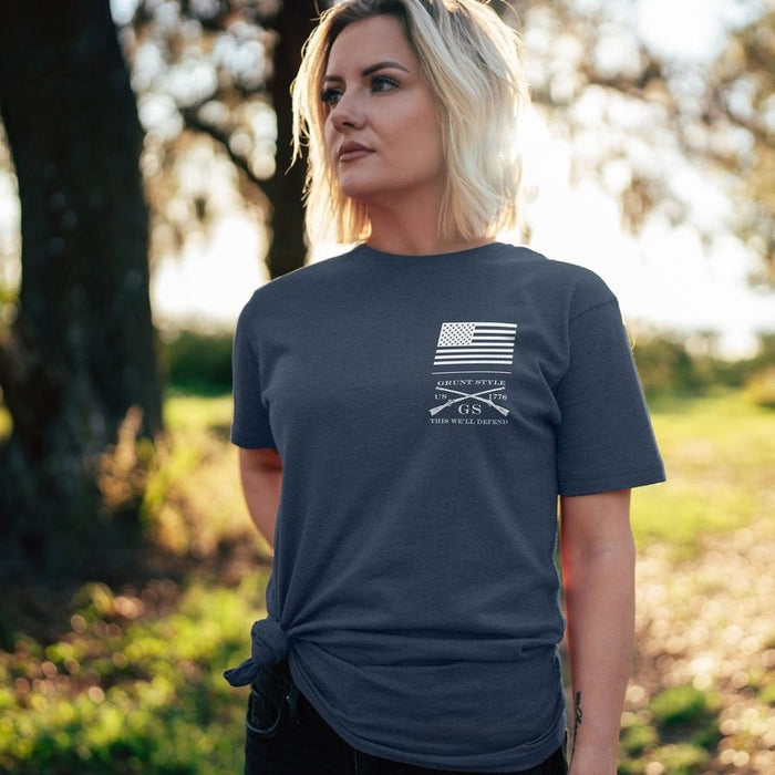 Woman wearing a dark blue t-shirt with a graphic design outdoors