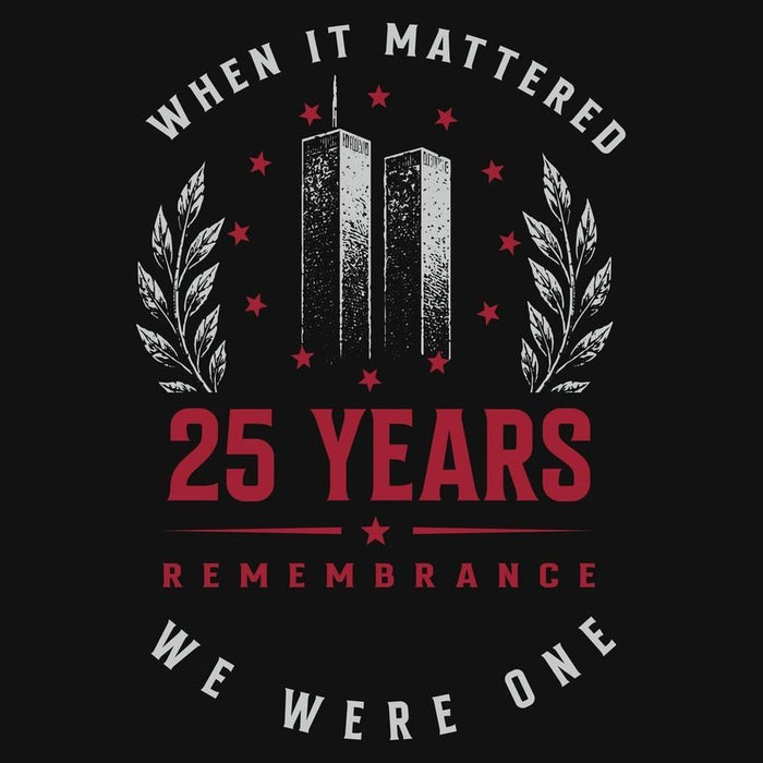 A black graphic print featuring the text 'WHEN IT MATTERED 25 YEARS REMEMBRANCE WE WERE ONE' with a central memorial design of two towers, red stars, and white laurel branches.